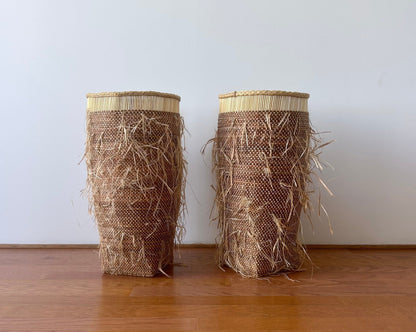 Tall floor standing storage baskets, natural colored with a shaggy textured exterior. Made in Ghana from local sustainable materials.