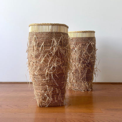 Tall floor standing storage baskets, natural colored with a shaggy textured exterior. Made in Ghana from local sustainable materials.