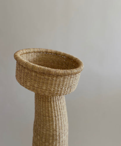 A large woven sculpture handcrafted from African grass.