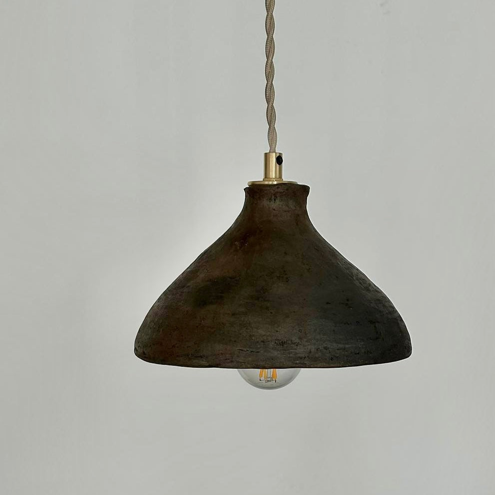 The Mud Pendant lights are a smaller conical shape, handmade in matte black ceramic in Northern Ghana. They work well in kitchens or dining areas.