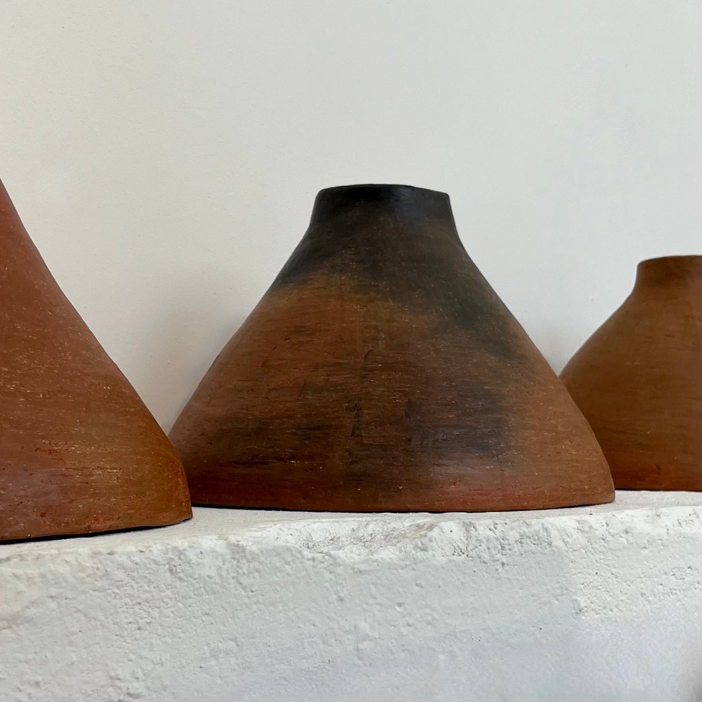 The Mud Pendant lights are a smaller conical shape, handmade in matte black ceramic in Northern Ghana. They work well in kitchens or dining areas.