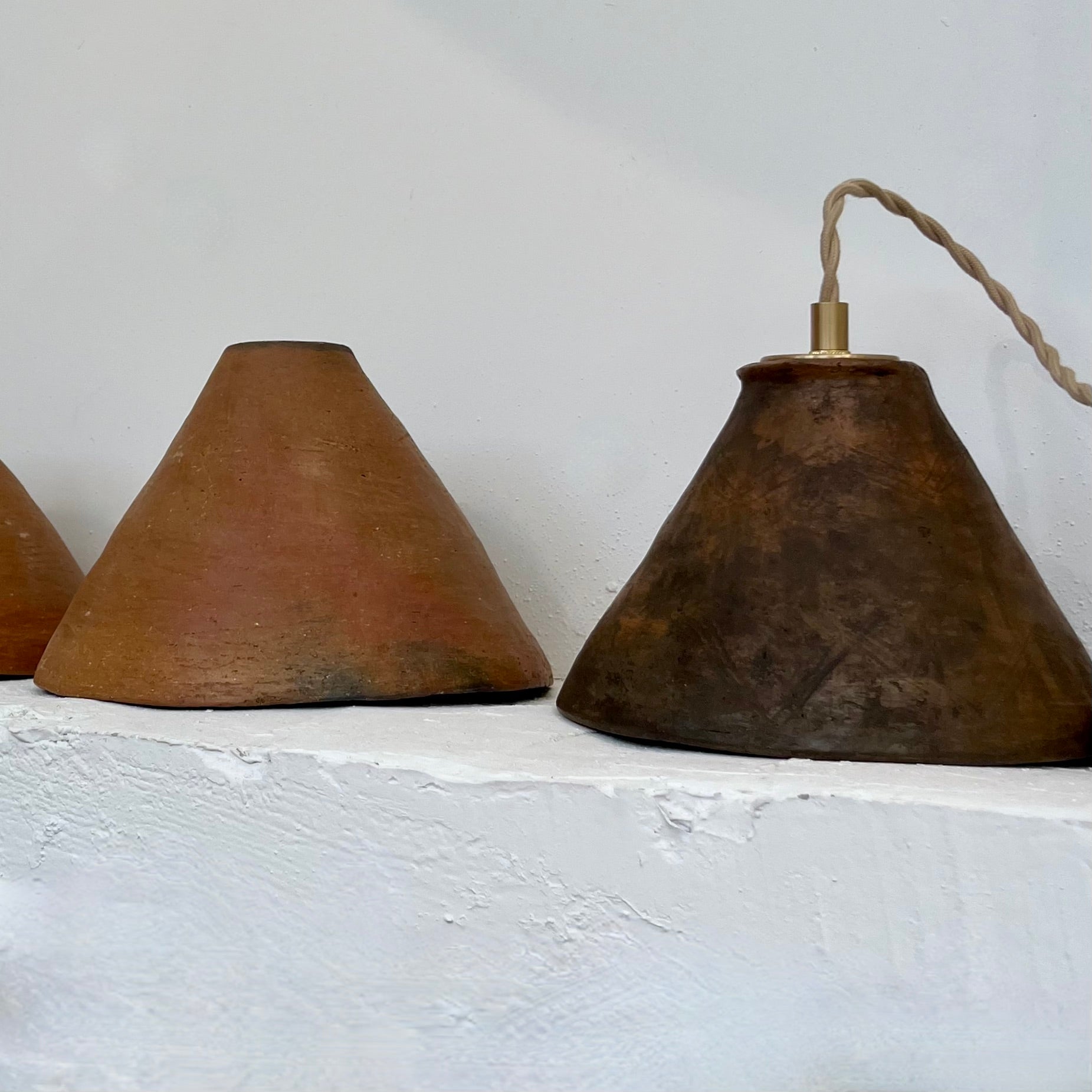 The Mud Pendant lights are a smaller conical shape, handmade in matte black ceramic in Northern Ghana. They work well in kitchens or dining areas.