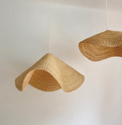 Two hand woven curved light shades made in Ghana.