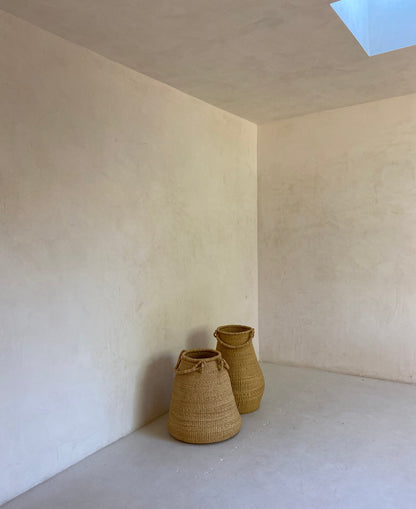 Two large gourd shaped baskets, hand woven from sustainable elephant grass in Ghana.