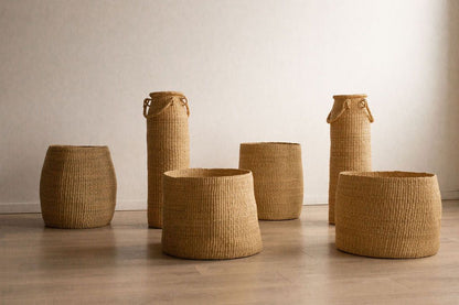 Many hand woven, natural  storage baskets.