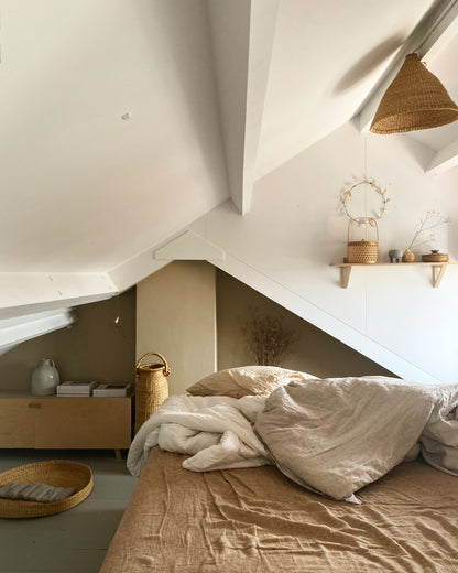 handwoven baskets and lampshade in a natural colored bedroom.