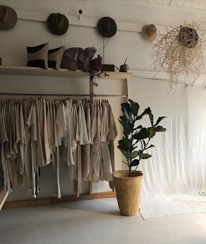 Large basket planter next to a clothes rail.