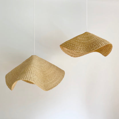 Two hand woven curved light shades made in Ghana.