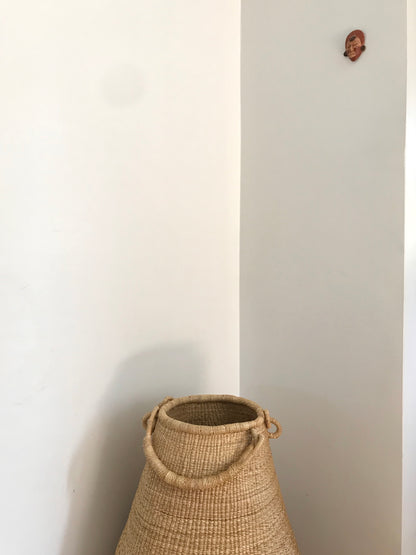 Oversized hand crafted floor basket, with handle.