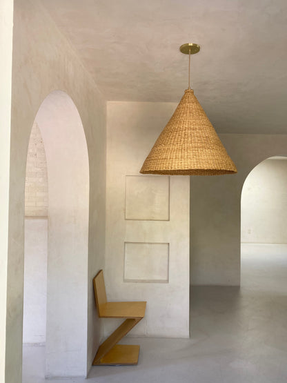 Our Bonnet pendant lights are a conical shape, handwoven from natural colored, indigenous elephant grass by members of a women’s organization in northern Ghana. A perfect-sized pendant for any room or living space.