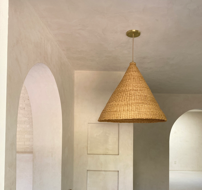 Our Bonnet pendant lights are a conical shape, handwoven from natural colored, indigenous elephant grass by members of a women’s organization in northern Ghana. A perfect-sized pendant for any room or living space.