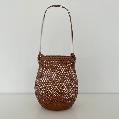 A small smoked bamboo basket handcrafted and hand woven by Japanese artist Mie Kodama.