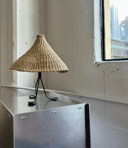 Modernist, iron table lamp from France circa 1950s. Paired with a coned shaped hand woven lamp shade.