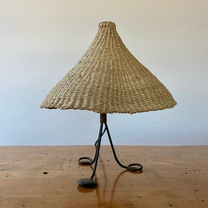 Modernist, iron table lamp from France circa 1950s. Paired with a coned shaped hand woven lamp shade.