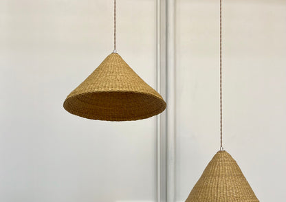 Our Bonnet pendant lights are a conical shape, handwoven from natural colored, indigenous elephant grass by members of a women’s organization in northern Ghana. A perfect-sized pendant for any room or living space.