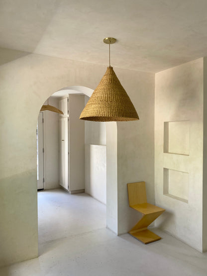 Our Bonnet pendant lights are a conical shape, handwoven from natural colored, indigenous elephant grass by members of a women’s organization in northern Ghana. A perfect-sized pendant for any room or living space.