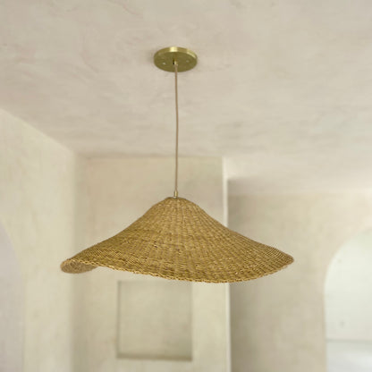 The Landslide pendant lights are made with natural colored, sustainable elephant grass in northern Ghana. Hand woven as a shallow cone and shaped into undulating waves, these lights are beautiful in bedrooms as well as living spaces.