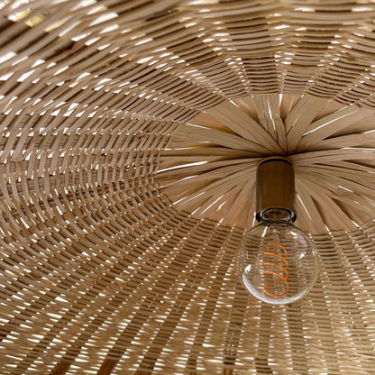 Showing the inside, hand woven texture of the Landslide pendant light shade and light bulb