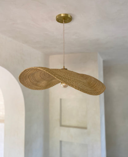 Our Fawn pendant lights are handwoven from natural colored elephant grass in northern Ghana.  Their wide and floating shape is striking in any living space, especially over a dining table or kitchen island.