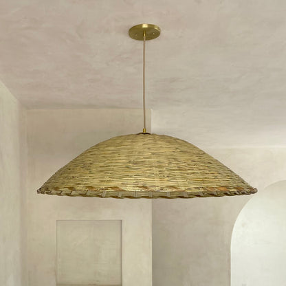 The Carrizo Pendant Light is a hand-woven, upside-down dish-shaped pendant light, made from a natural colored, bamboo-like river reed by skilled craftspeople in Oaxaca, Mexico. An ideal pendant for any space where you wish to have a warm downward light.