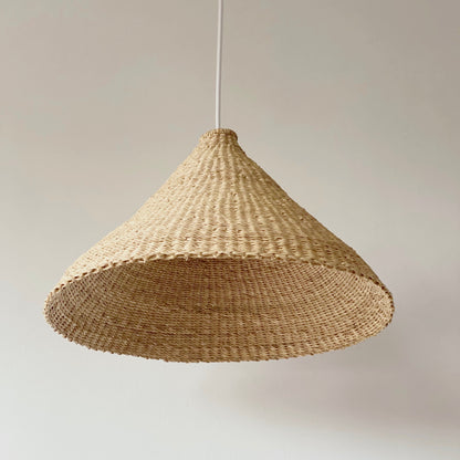 Our Bonnet light shades are handwoven from sustainable elephant grass in Ghana. These natural colored, conical shaped shades are perfect for bedrooms, hallways, kitchens and living spaces.