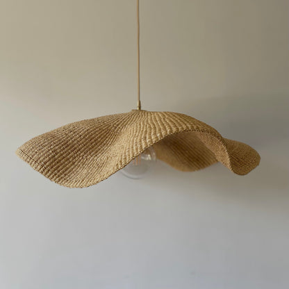 Fawn light shade handwoven from sustainable elephant grass in Ghana. Their wide and floating shape are striking in any living space, especially in bedrooms or over dining tables.