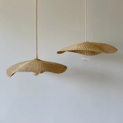 Two Fawn light shades, handwoven from sustainable elephant grass in Ghana. Their wide and floating shape are striking in any living space, especially in bedrooms or over dining tables.