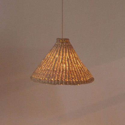 Our lit up Bonnet light shade. They are handwoven from sustainable elephant grass in Ghana. These natural colored, conical shaped shades are perfect for bedrooms, hallways, kitchens and living spaces.