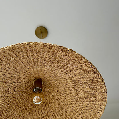 Showing the inside, hand woven texture of the Sunhat pendant light, and its flush ceiling mount.