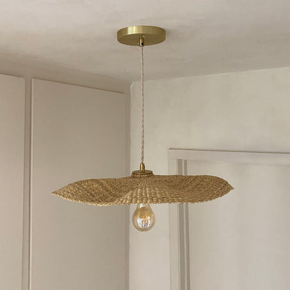 Our Fawn pendant lights are handwoven from natural colored elephant grass in northern Ghana.  Their wide and floating shape is striking in any living space, especially over a dining table or kitchen island.