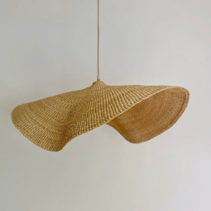 Our Fawn light shades are handwoven from sustainable elephant grass in Ghana. Their wide and floating shape are striking in any living space, especially in bedrooms or over dining tables.