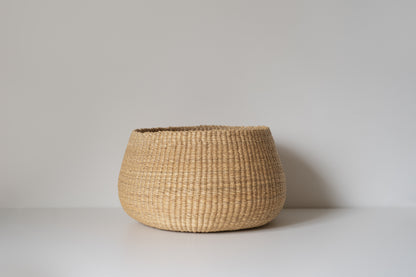 Small handwoven baskets made from natural colored elephant grass.