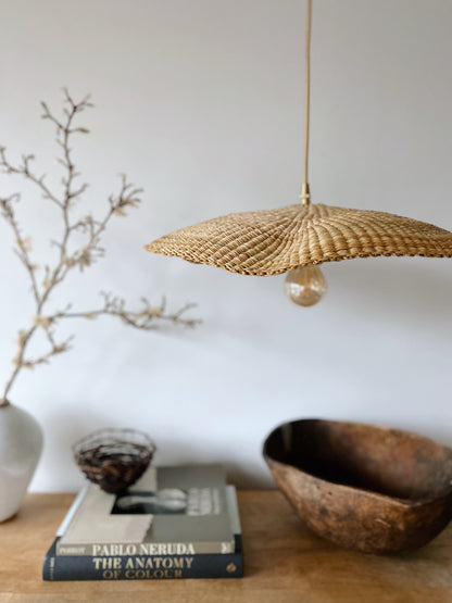 Fawn light shades are handwoven from sustainable elephant grass in Ghana. Their wide and floating shape are striking in any living space, especially in bedrooms or over dining tables.