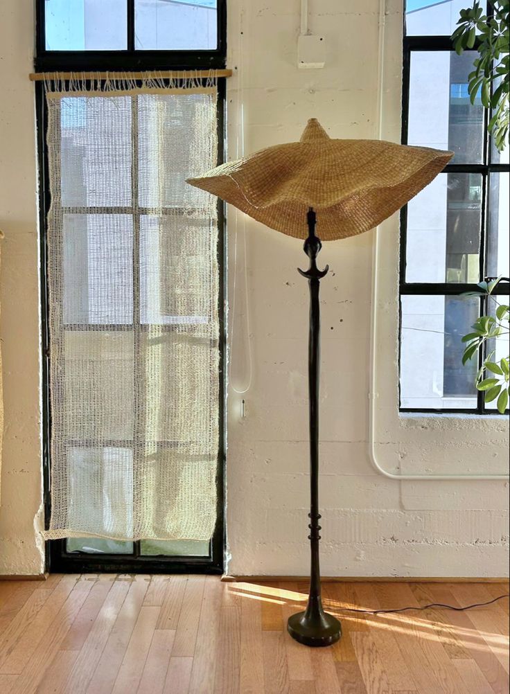 Woven light shade on floor lamp, handwoven from sustainable elephant grass in Ghana. 