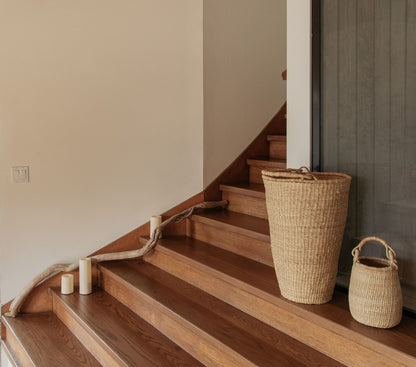 Handwoven baskets on stairs, made from natural colored elephant grass, from northern Ghana.