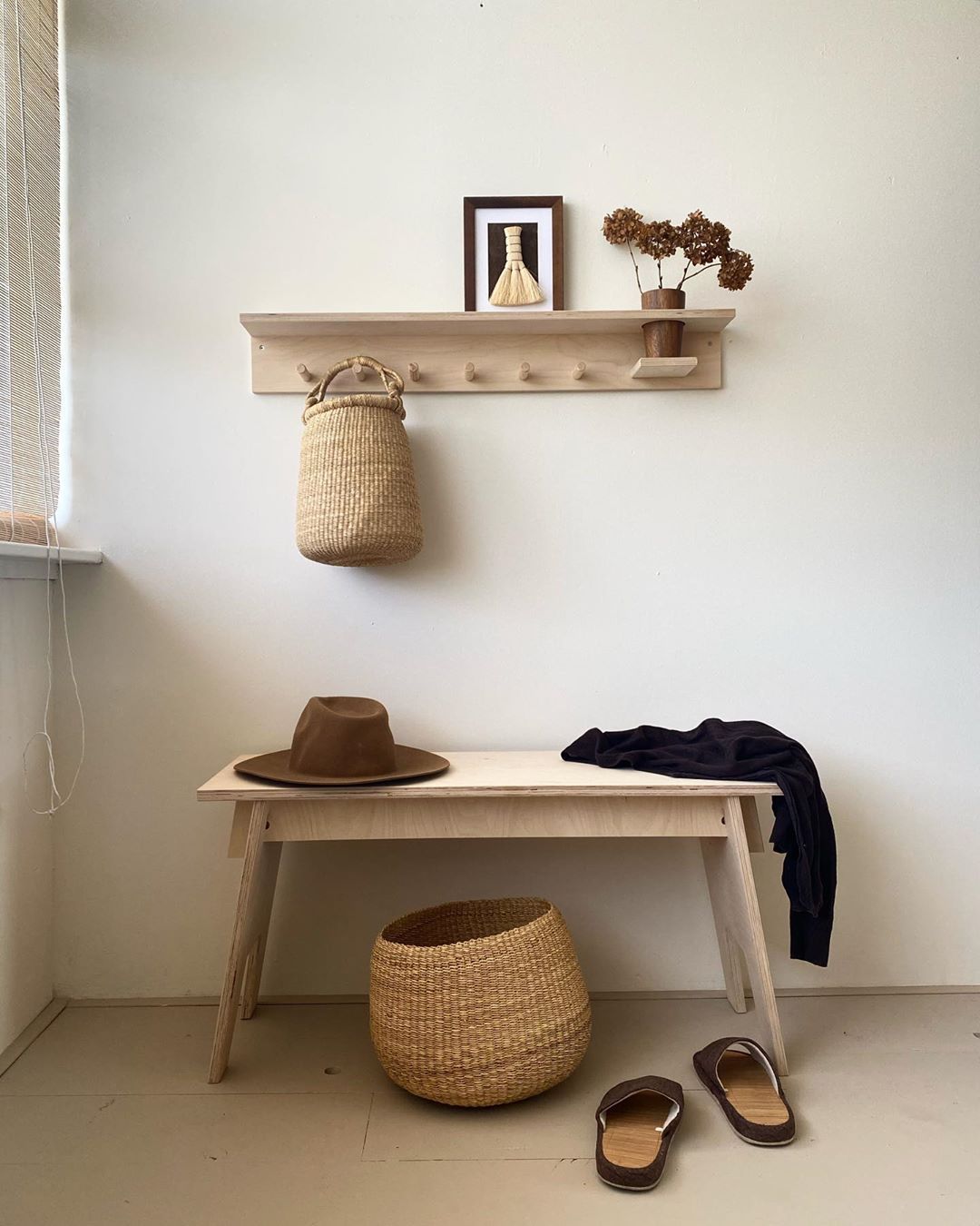 Small handwoven baskets in a hallway, made from natural colored elephant grass, from northern Ghana.