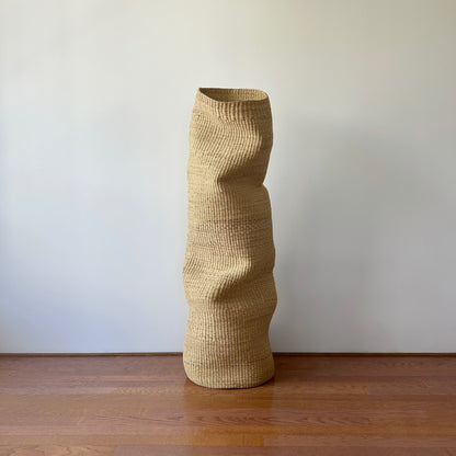 A large woven sculpture handcrafted from natural materials.