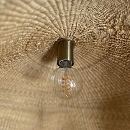 Showing the inside, hand woven texture of the Fawn pendant light shade with light blub.