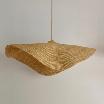 Fawn light shade handwoven from sustainable elephant grass in Ghana. Their wide and floating shape are striking in any living space, especially in bedrooms or over dining tables.