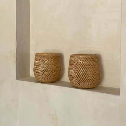 Two round bowl shaped bamboo baskets, handcrafted and hand woven by Japanese artist Mie Kodama.