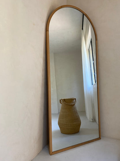 Large handwoven basket reflected in a mirror.